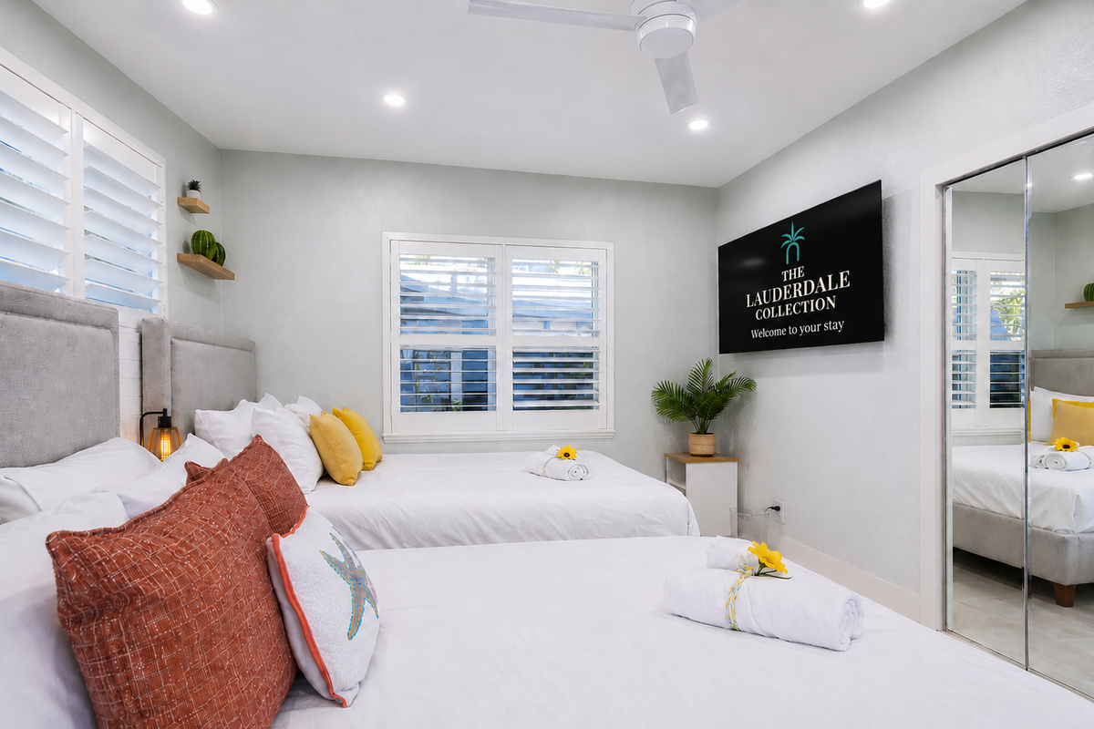 Two queen beds and straight out to the backyard — comfort meets fresh air 🌿- equipped w/ a Smart TV