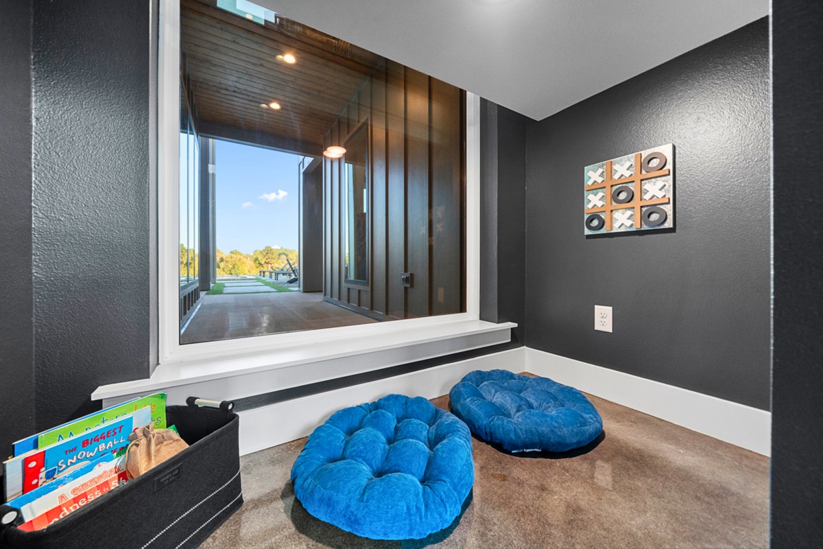 This cozy corner is a haven for quiet moments and relaxation with a book under the stairs for the kids!