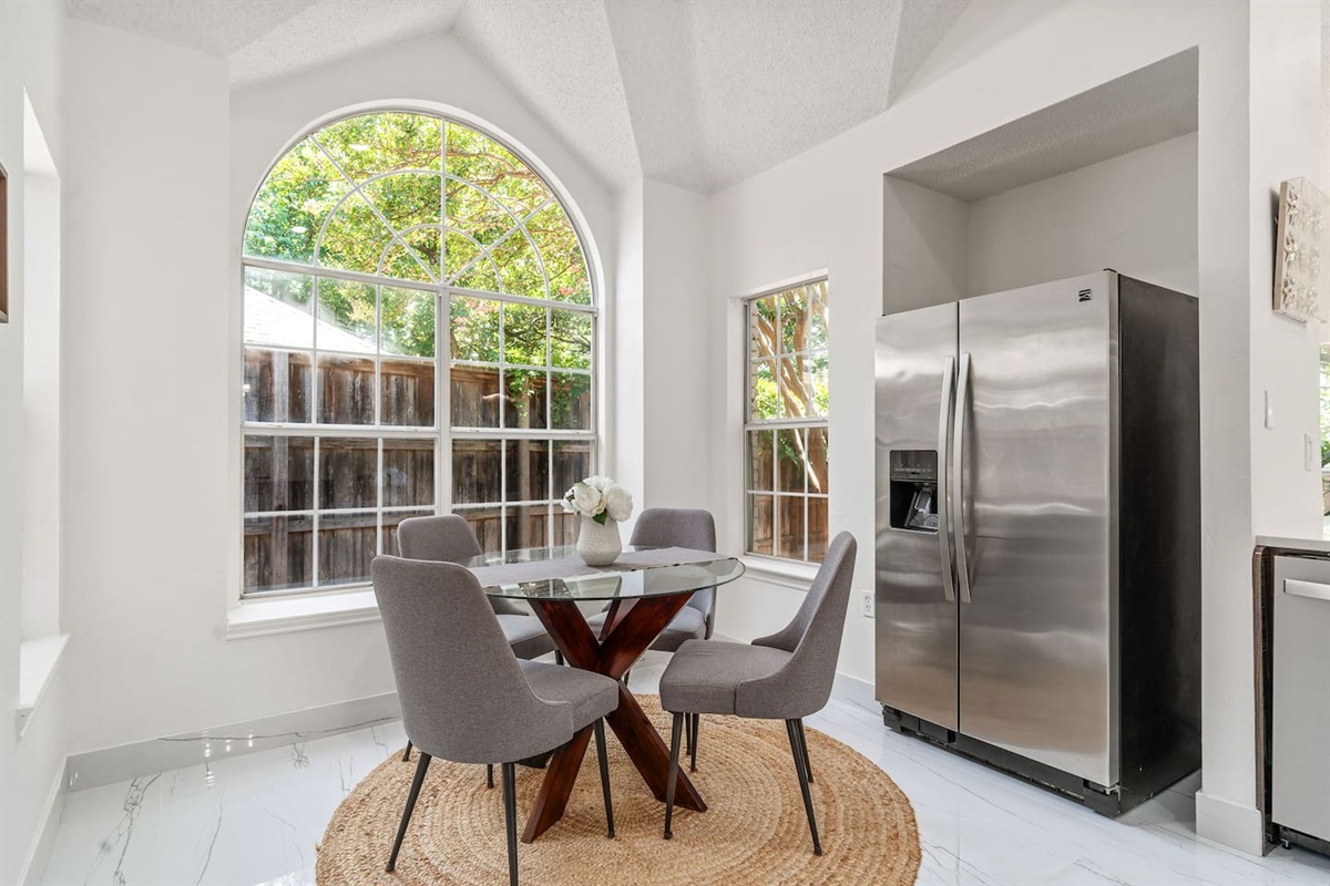 Bright and modern kitchen nook adjacent to the kitchen with seating for four.
