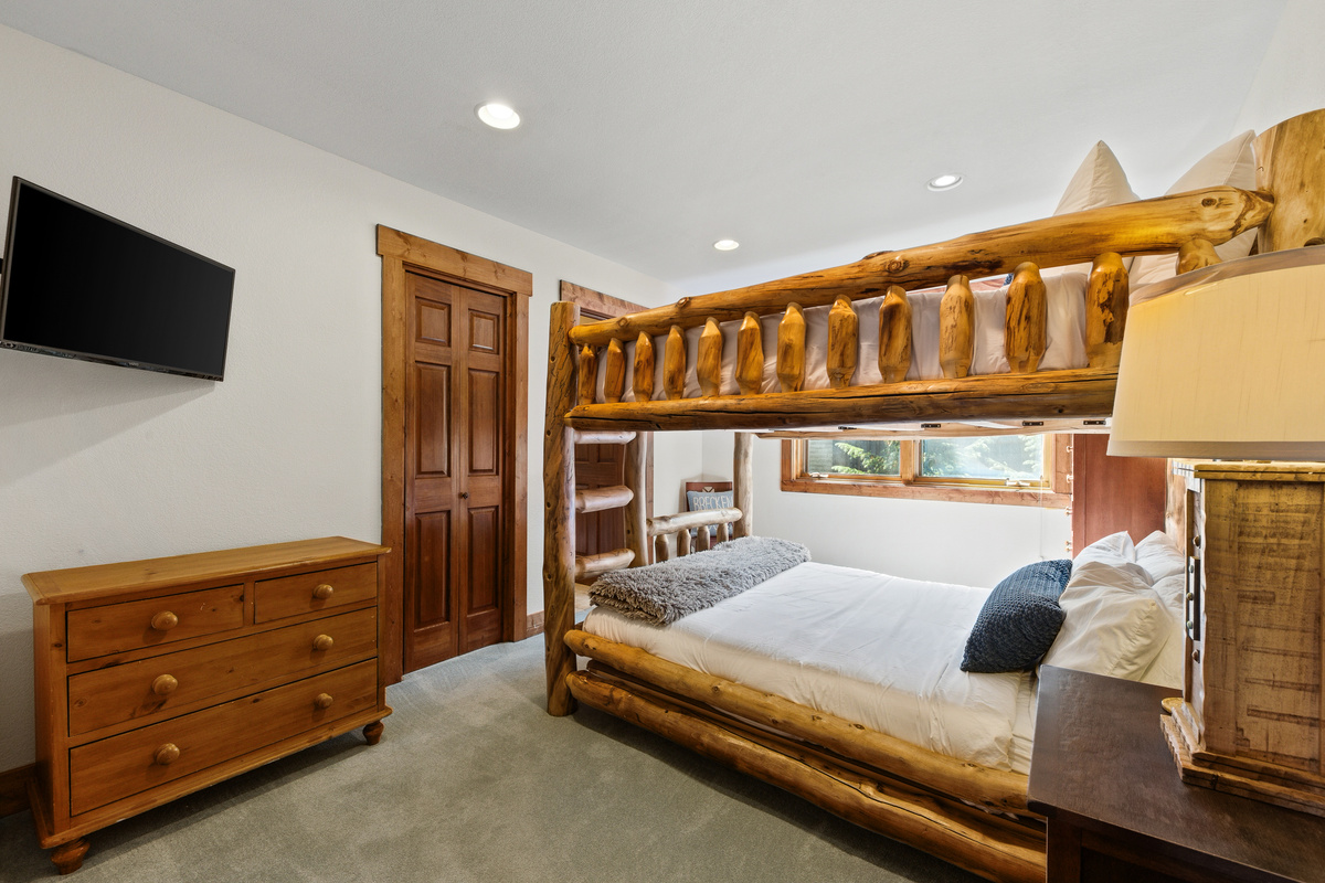 Upper level guest bedroom #2 with Queen-over-Queen bunk, tv, large window, and attached bathroom with shower. 