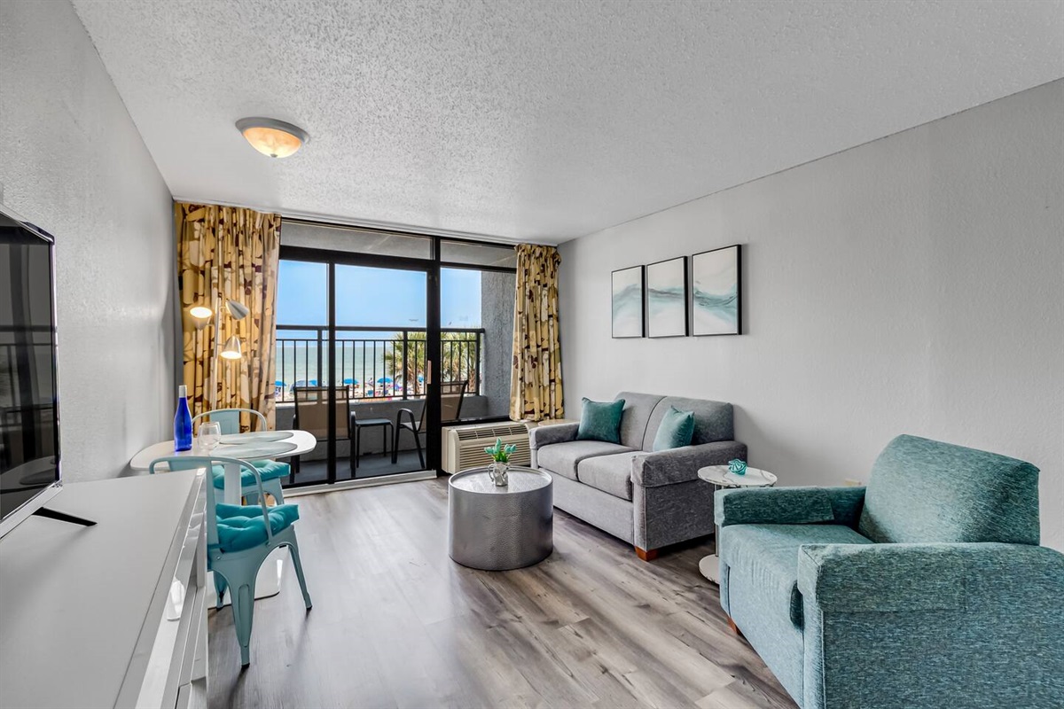 Allow the gentle sea breeze and soothing sound of waves to create a calming soundtrack for your time spent in the living room, enhancing the overall coastal experience.