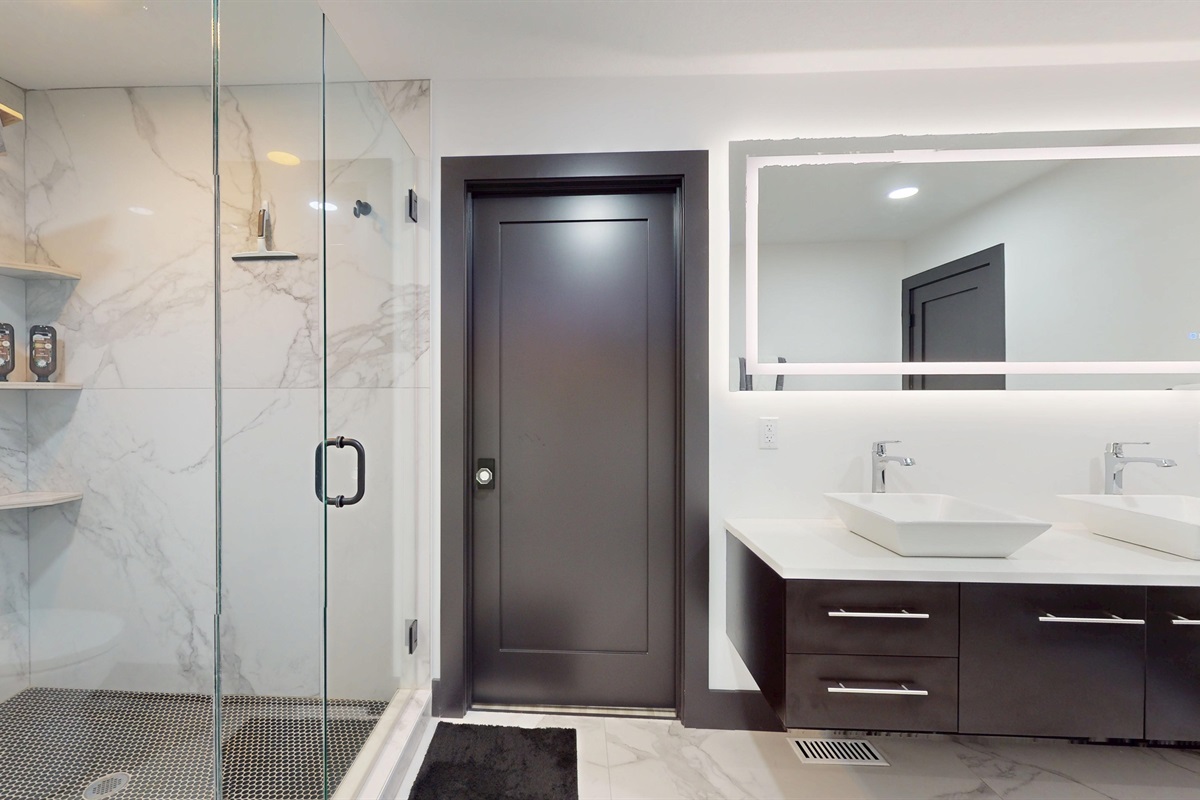 The main primary bathroom has an entry into the Primary Walk-In Closet and an entry into the Primary Bedroom.