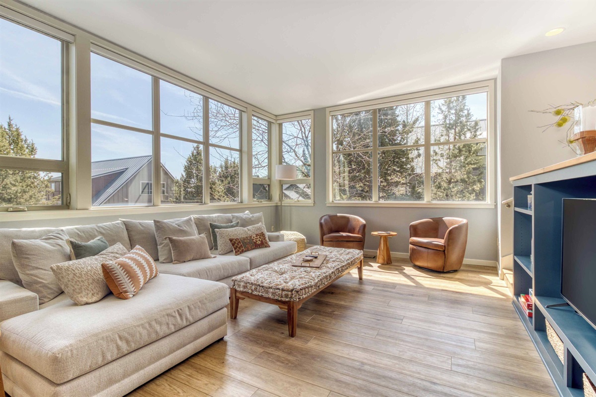 Open concept layout with plush seating and natural light