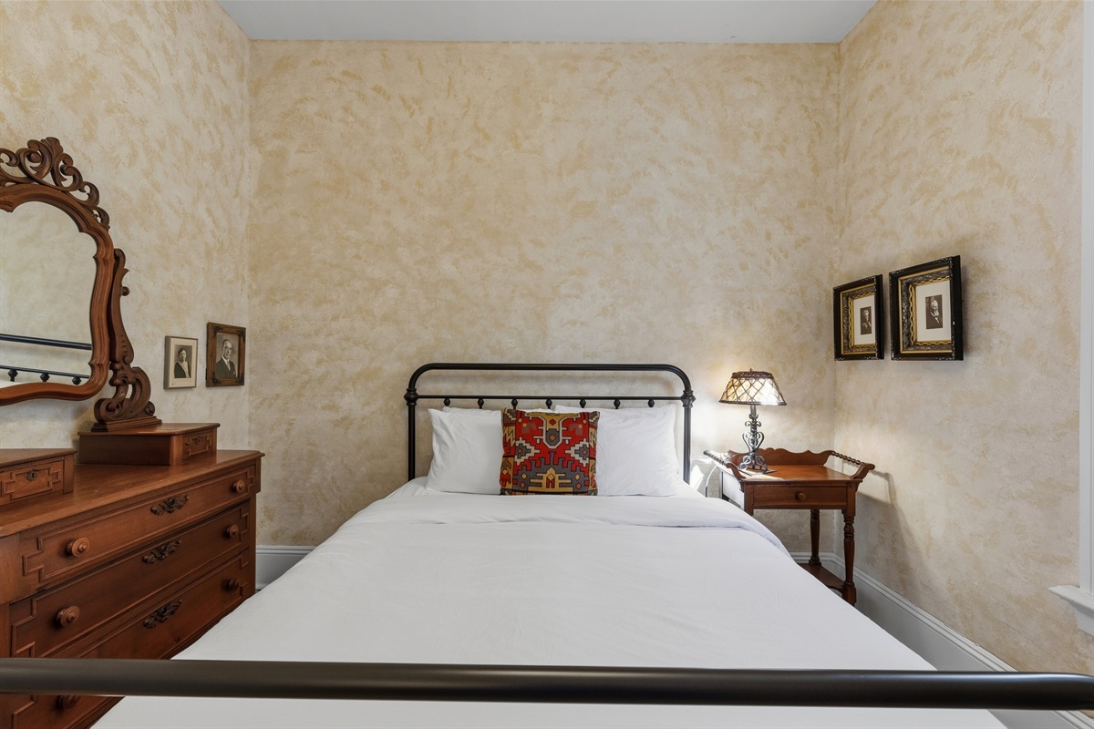 Queen bedroom w/ soft lighting & vintage-style decor