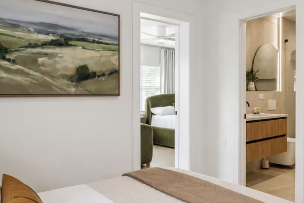 Comfortable guest bedroom with convenient access to the adjacent bathroom.