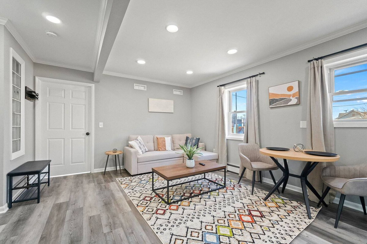 Stylish living and dining area featuring a chic center table and large windows that let in plenty of natural light.