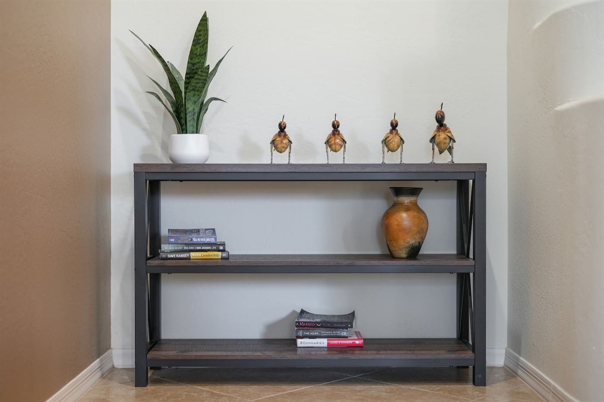 Stylish console table vignette with curated décor, adding a warm and refined touch.