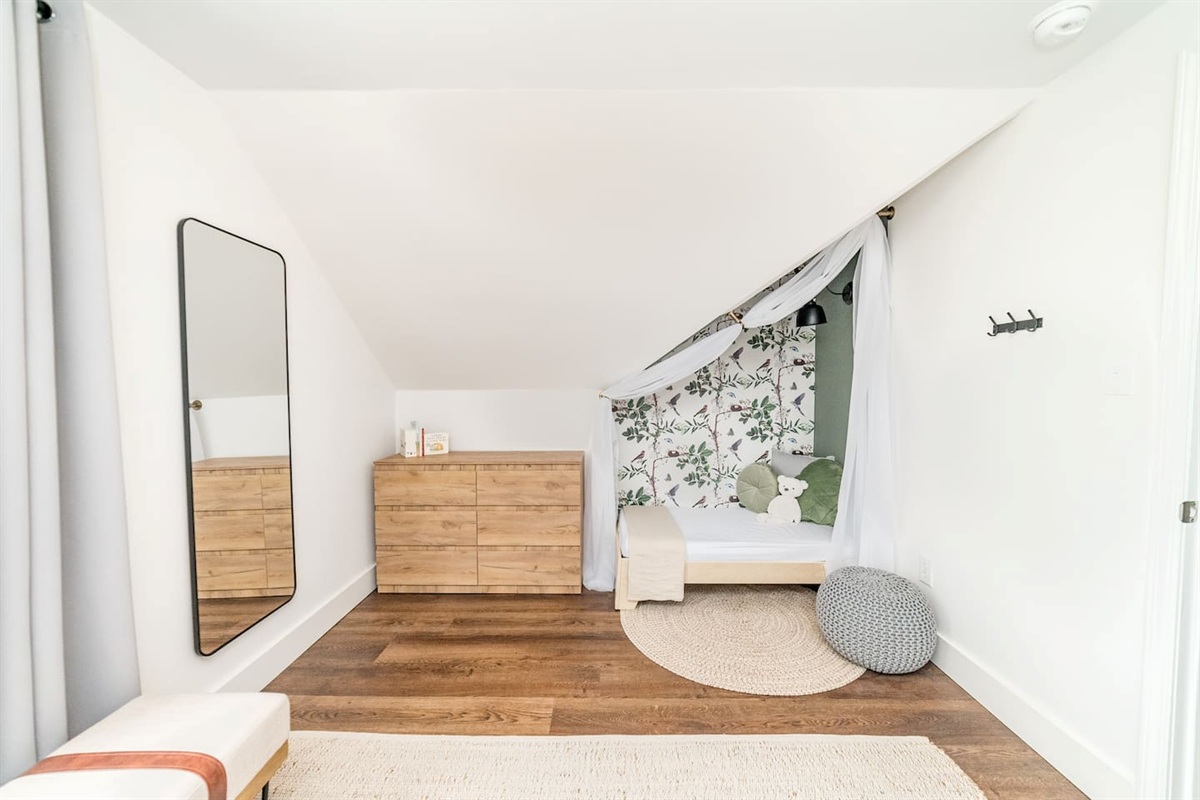 Across from the twin beds in Bedroom #5 is a dresser and a cute toddler bed alcove!