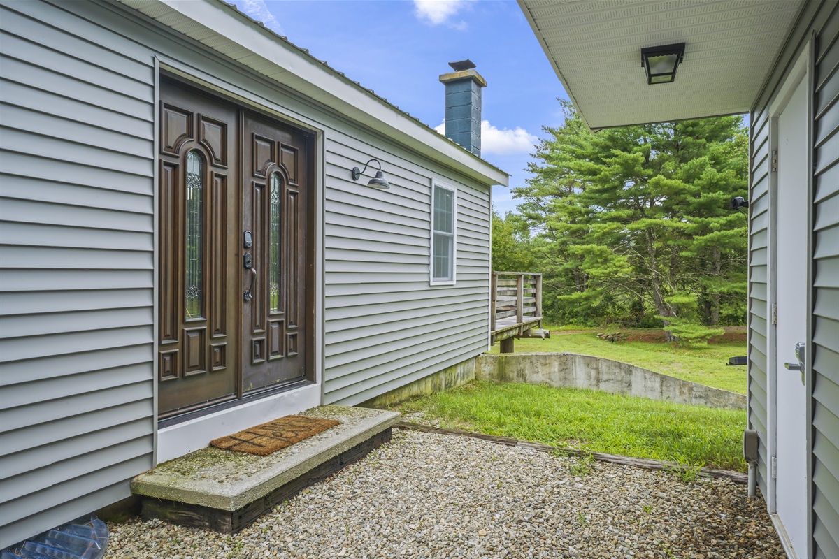 Entrance to house, brown doors on the left