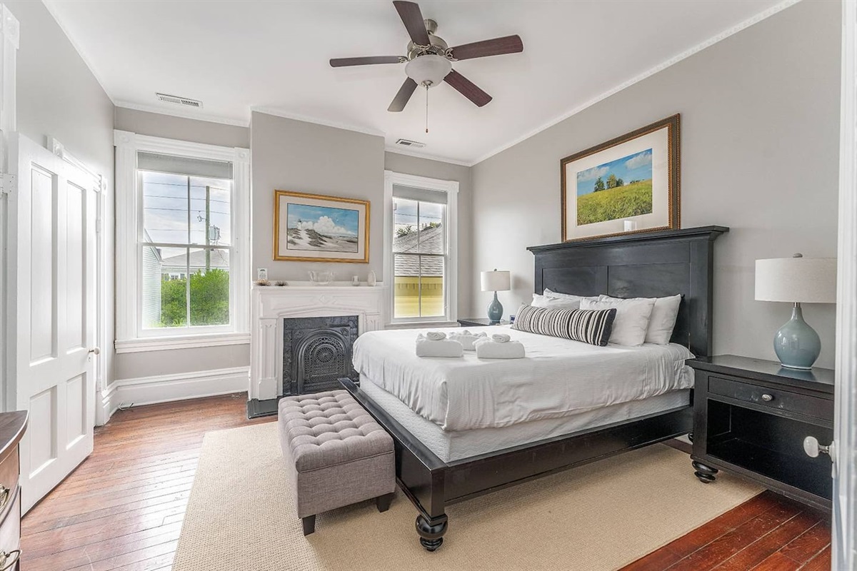 Well appointed bedroom with a queen mattress and high-end furnishings.  Two large windows between the ornate slate fireplace invite you in to kick your feet up and watch the game, read a book, or take a guilt-free nap.