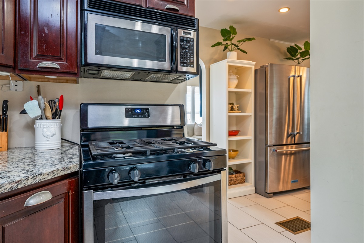 Cook with ease in a well-equipped kitchen featuring rich wood cabinetry and modern appliances 🍳☕🔪
