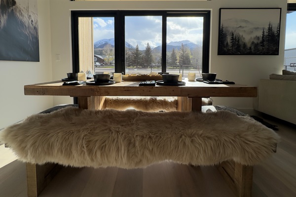 Genuine sheepskin over farm style benches with cowhide ottomans.  Enjoy a home cooked meal at the farmhouse style table and enjoy views of the gore range.