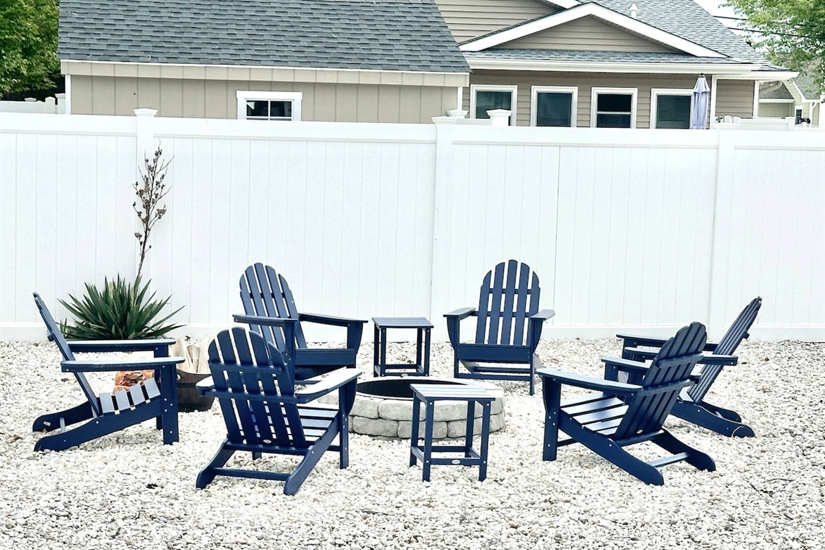 Gather around our stone fire pit for the ultimate evening under the stars. With six comfortable blue Adirondack chairs set on a tidy gravel base and enclosed by a privacy fence, it’s the perfect spot for roasting marshmallows and making memories.