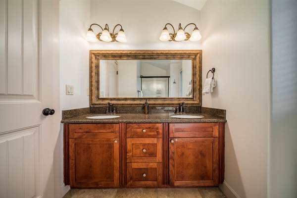Private bathroom with dual sinks and walk in shower