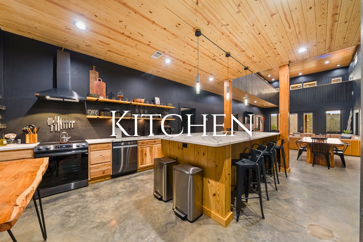 The spacious kitchen is designed for gathering, with plenty of counter space, warm wood cabinetry, and room for everyone to jump in and help with meals.