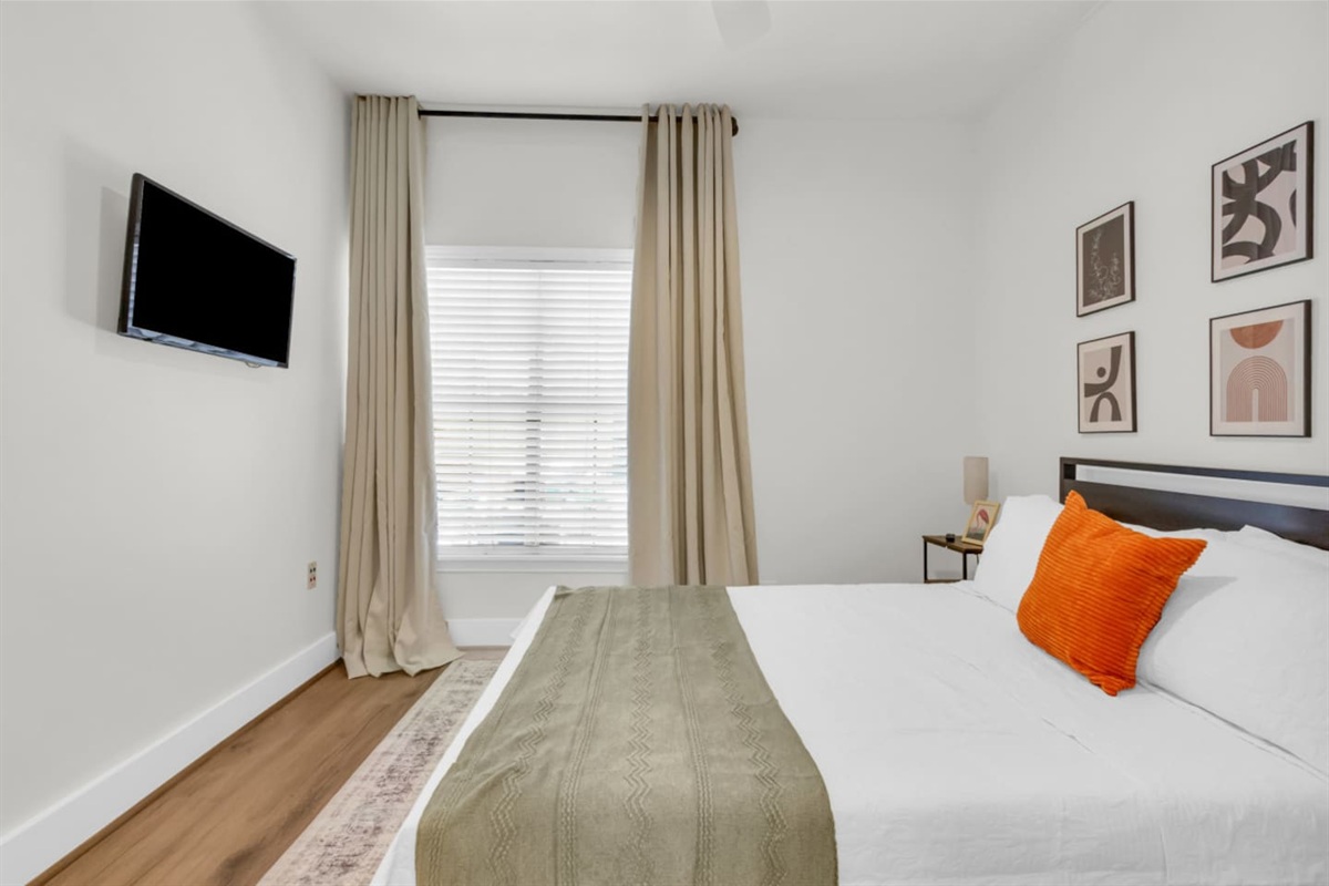 Queen bedroom with queen bed and TV.