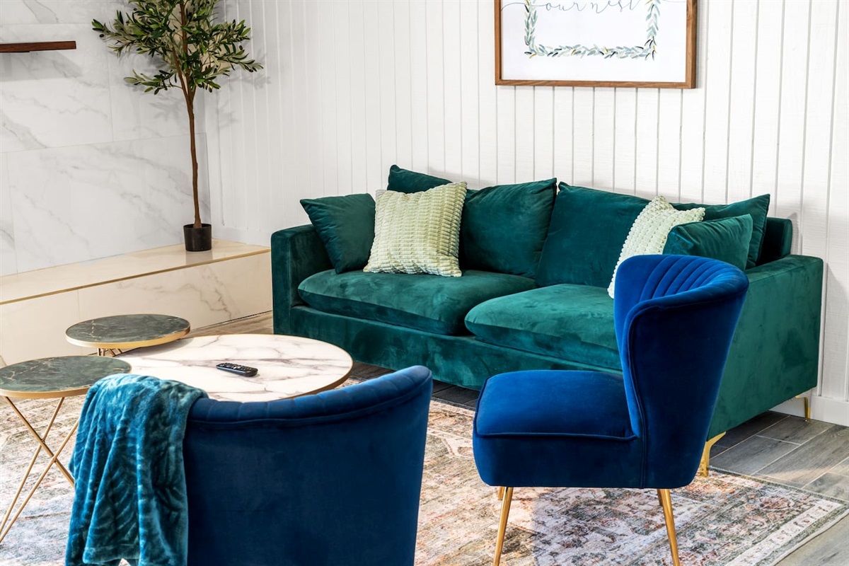 Relax in this stylish living room with plush seating, smart TV, and natural light—perfect for groups and families.