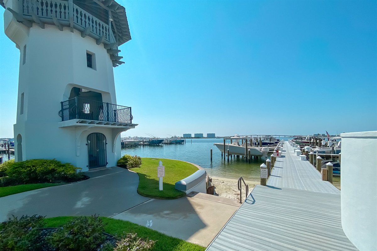 The iconic lighthouse stands as a beacon of coastal charm, overlooking the serene marina. This is the perfect spot to start a day of boating or simply enjoy the peaceful bay views.