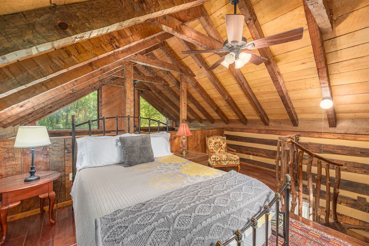 The loft bedroom is up a thick spiral staircase that climbs to the cozy bedroom