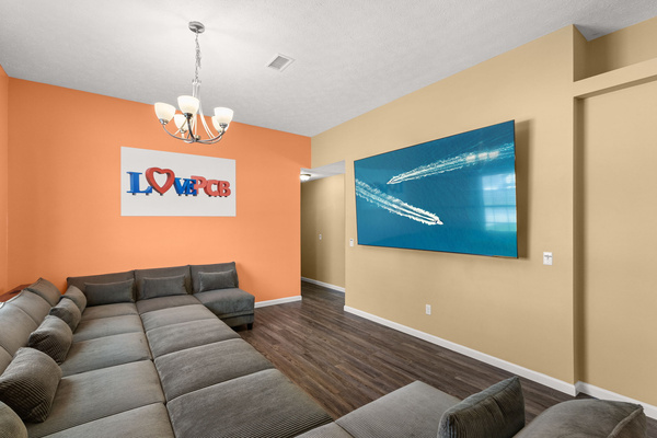 A huge modular sectional, four movable ottomans, and a massive 98‑inch TV make this front room the perfect gathering spot. Rearrange the space however you like — movie marathons, game days, or just kicking back after the beach.