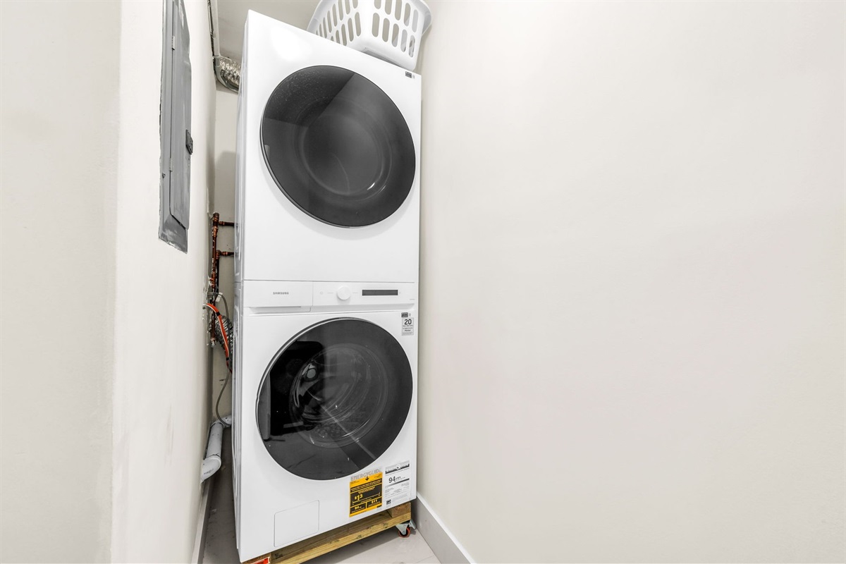 Stacked Samsung washer and dryer available for guest use—perfect for extended stays and pool days.