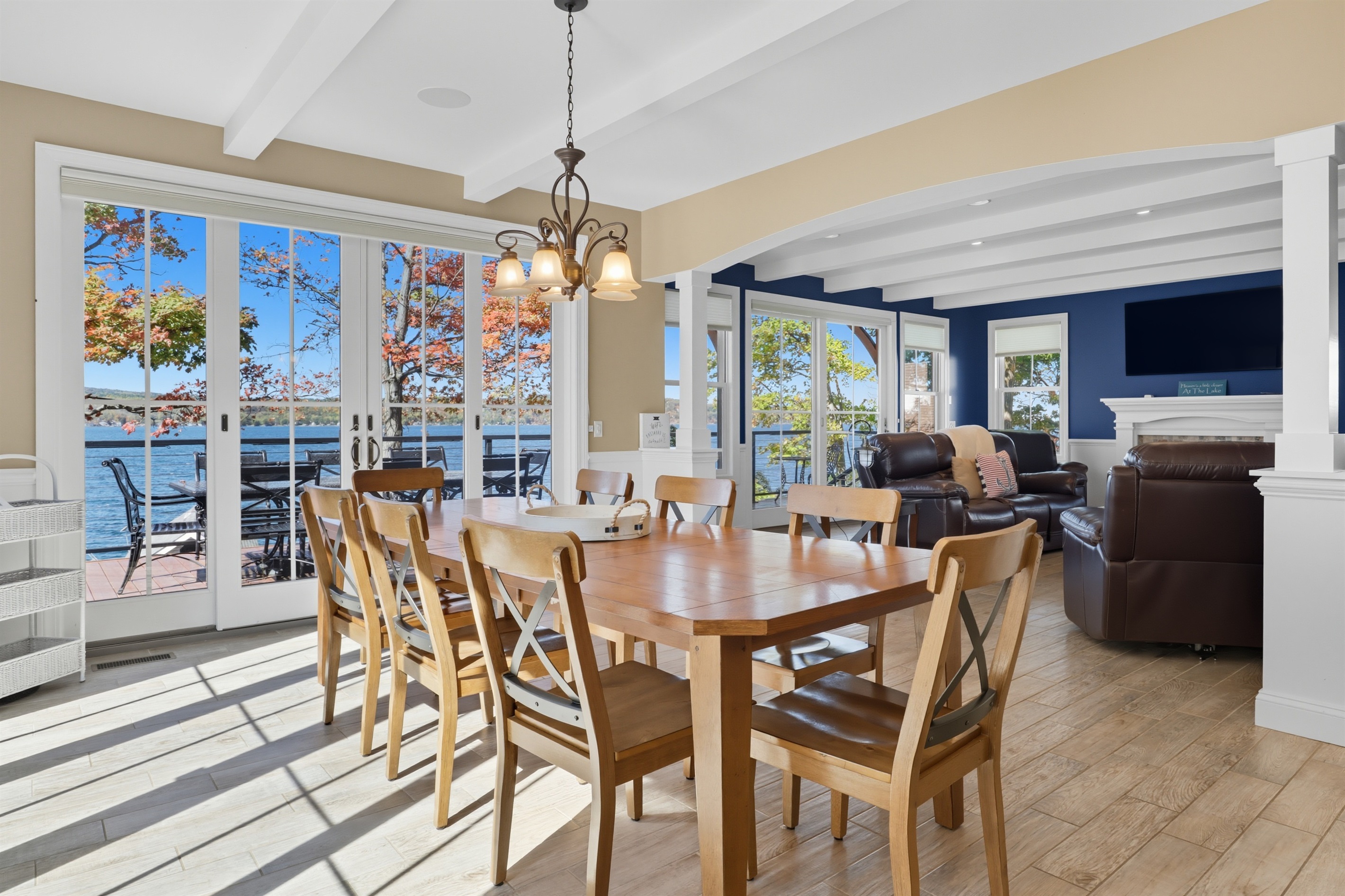 Sunny dining area with expansive windows and lake views.