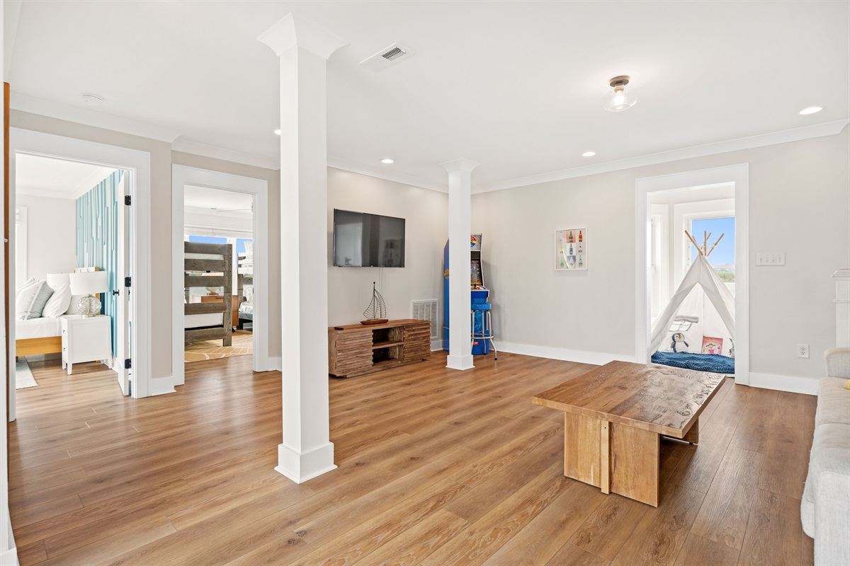 Versatile 2nd-floor living/game room and lounge featuring a queen sleeper sofa for additional sleeping space