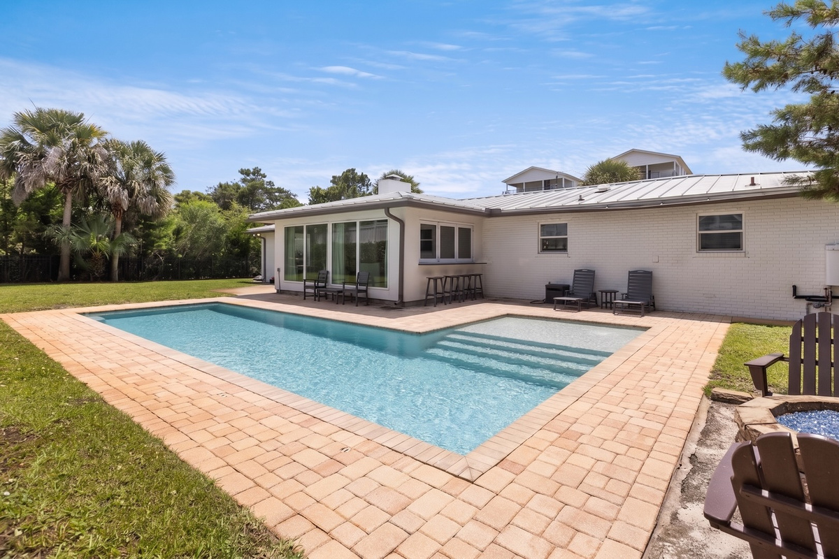 A private pool anchors the backyard, setting the scene for long afternoons under the Florida sun.