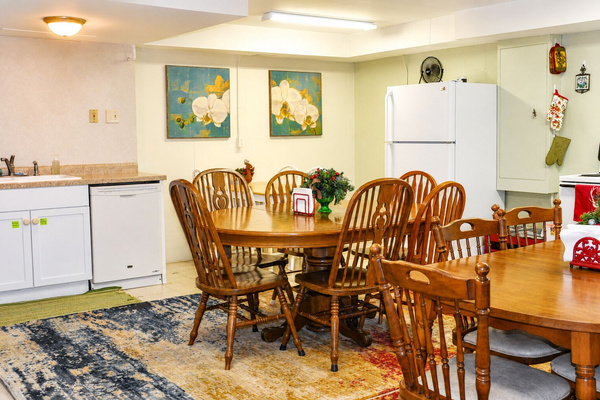 This lower-level kitchen may remind you of a classic church supper or community gathering space — warm, functional, and ready for family meals.