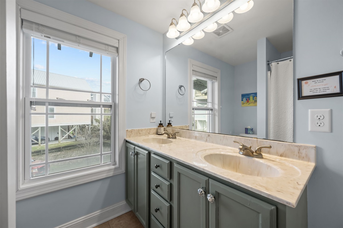2nd full bathroom with dual sinks, plenty of storage and a tub/shower. Adjacent to 1st floor queen bedroom, just a few steps down the hall from double full bedroom