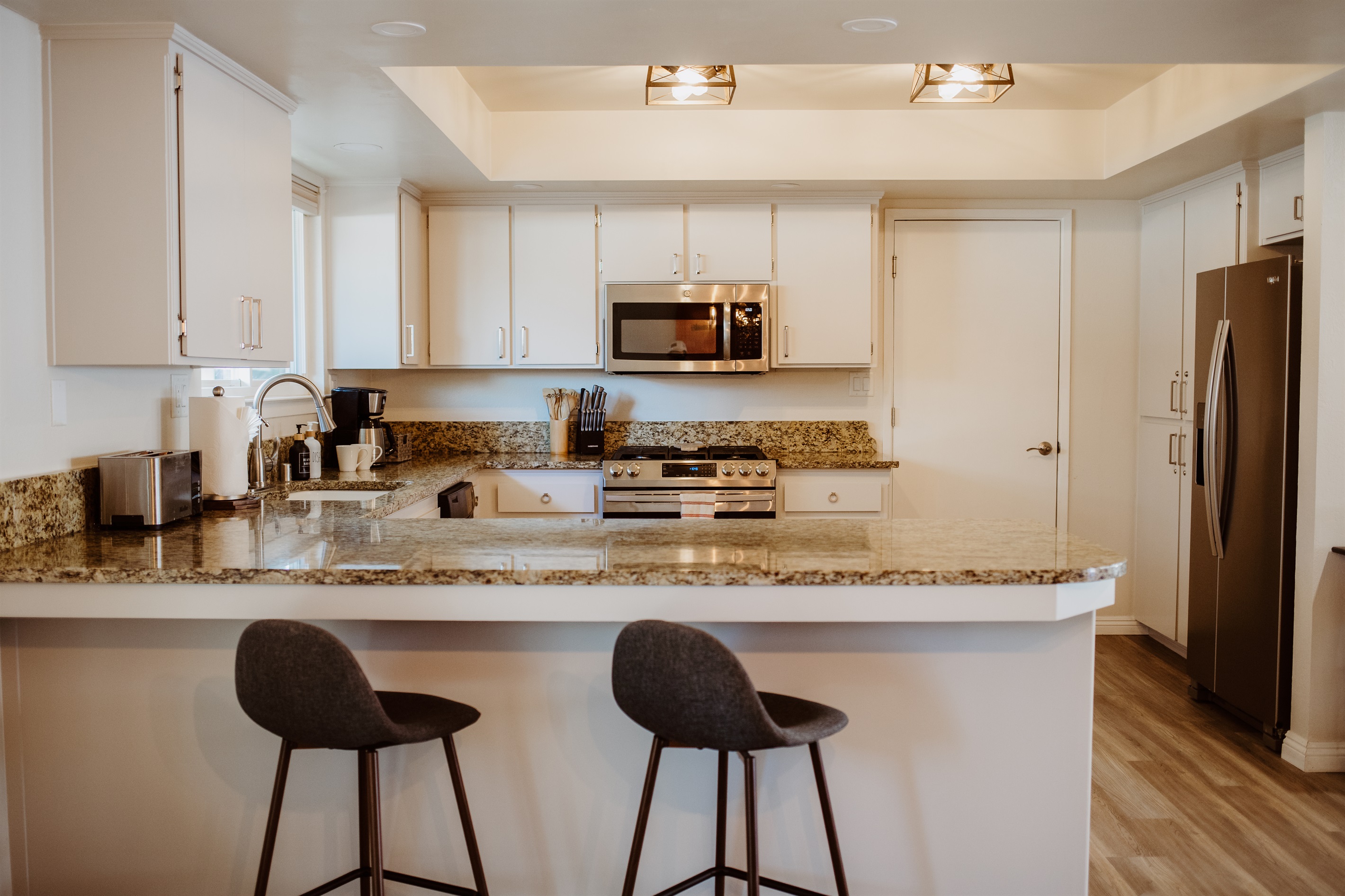 Stylish gourmet kitchen with breakfast bar seating.