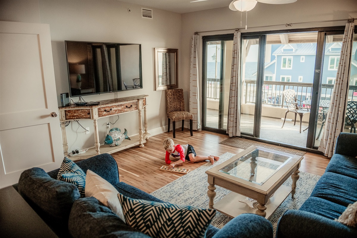 Family fun and relaxation station! That's a 65" smart HD TV with cable and apps (Prime, Netflix, etc). Seeing the ocean from the comfy sofas is just WOW.