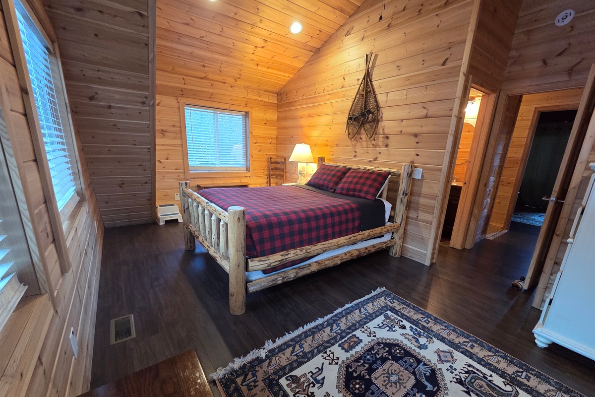 Upstairs, the second bedroom offers a cozy queen-size bed for a restful night’s sleep.