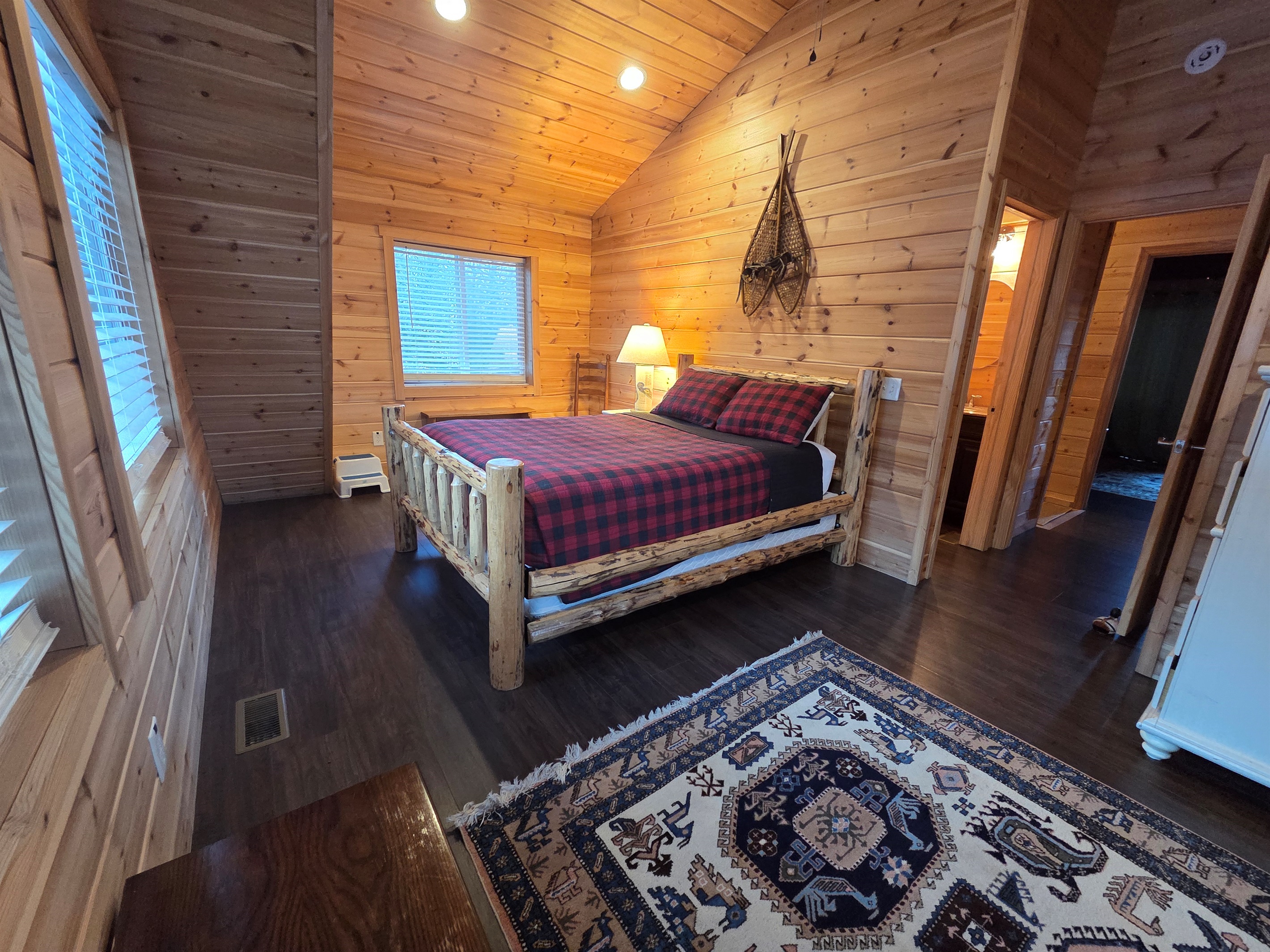 Upstairs, the second bedroom offers a cozy queen-size bed for a restful night’s sleep.