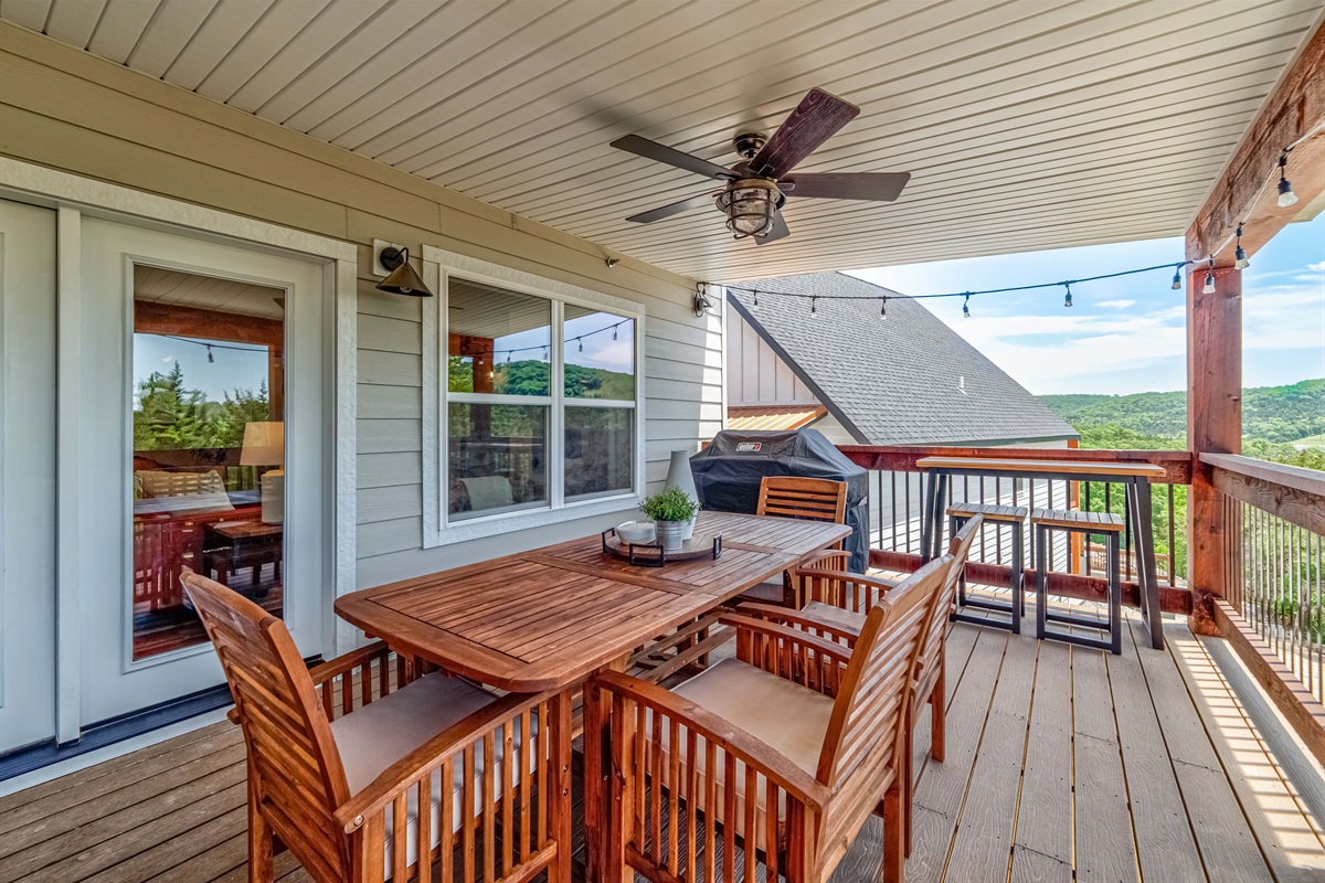 Outdoor dining with a forrested lake view