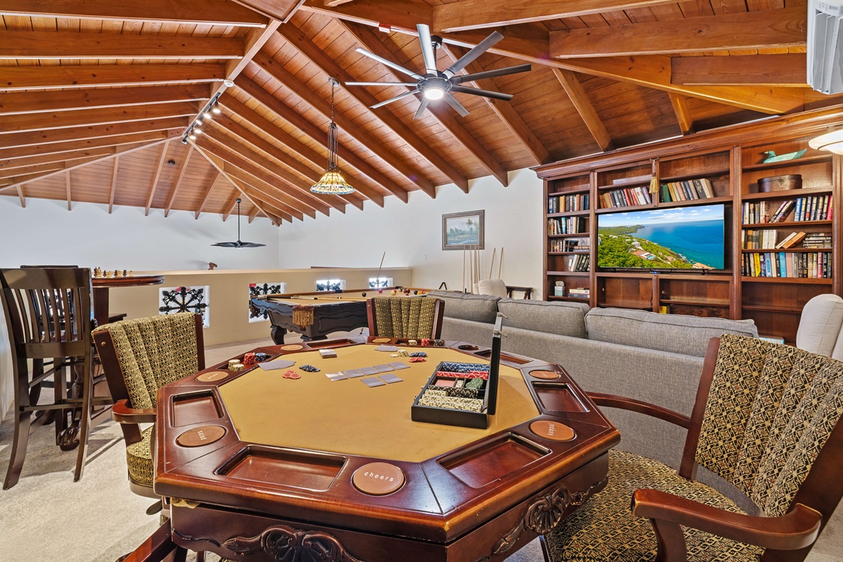 This game room is air conditioned and open to the living area below.