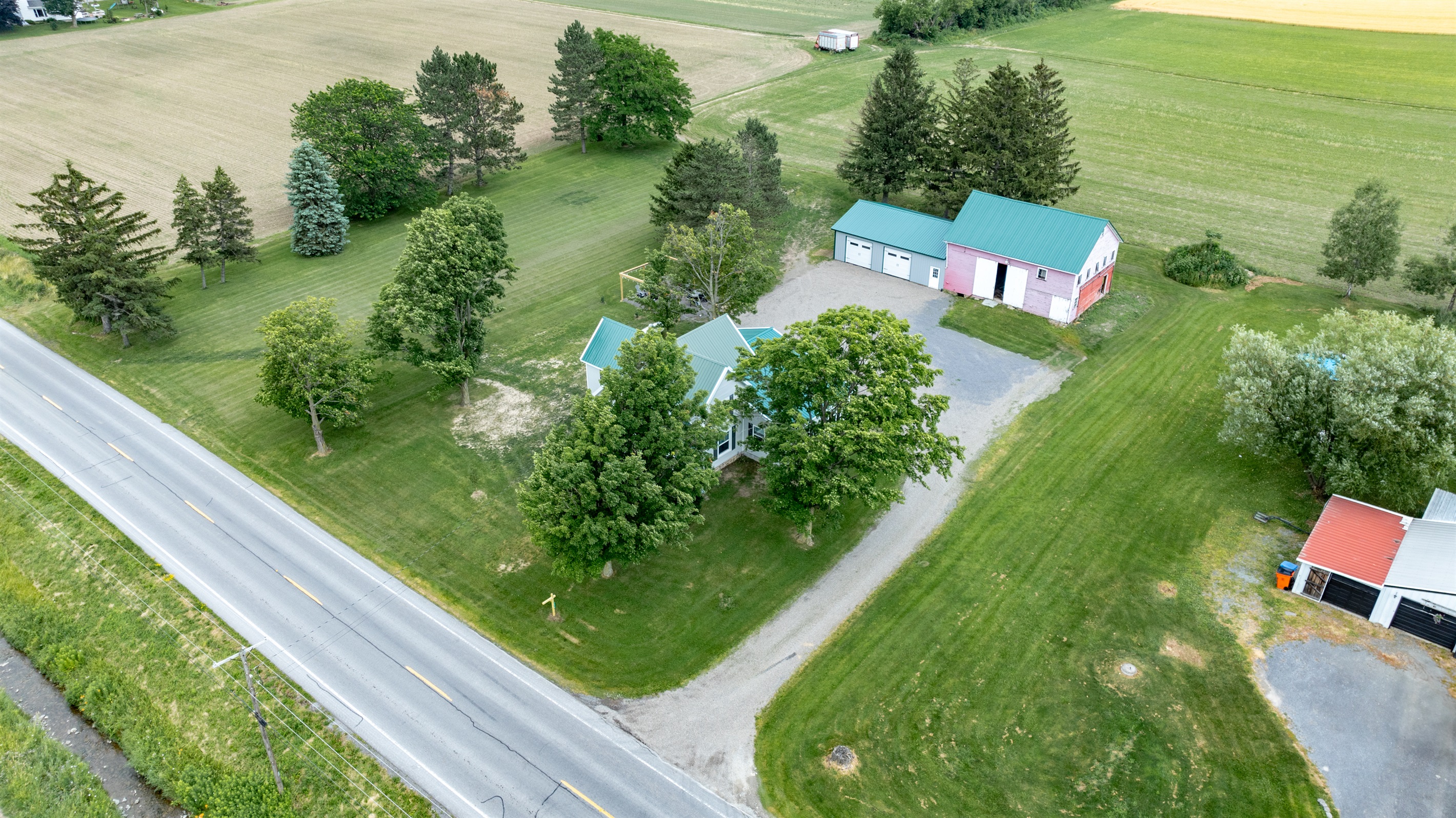 Peaceful country living with a charming home, spacious barn, and wide open green space—perfect for outdoor lovers and hobbyists alike.