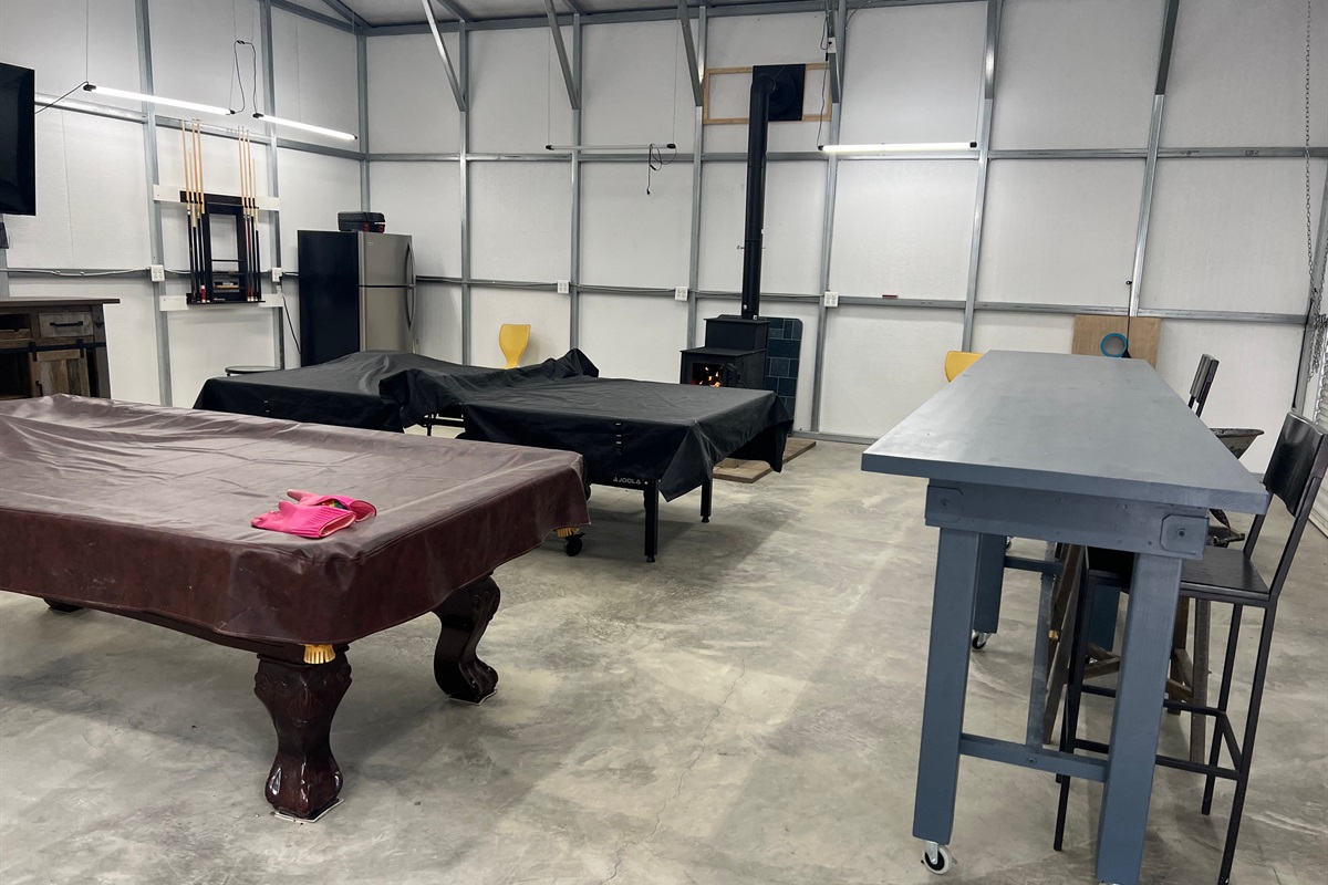 The game room now has a smart TV and a stylish bar with seating.
