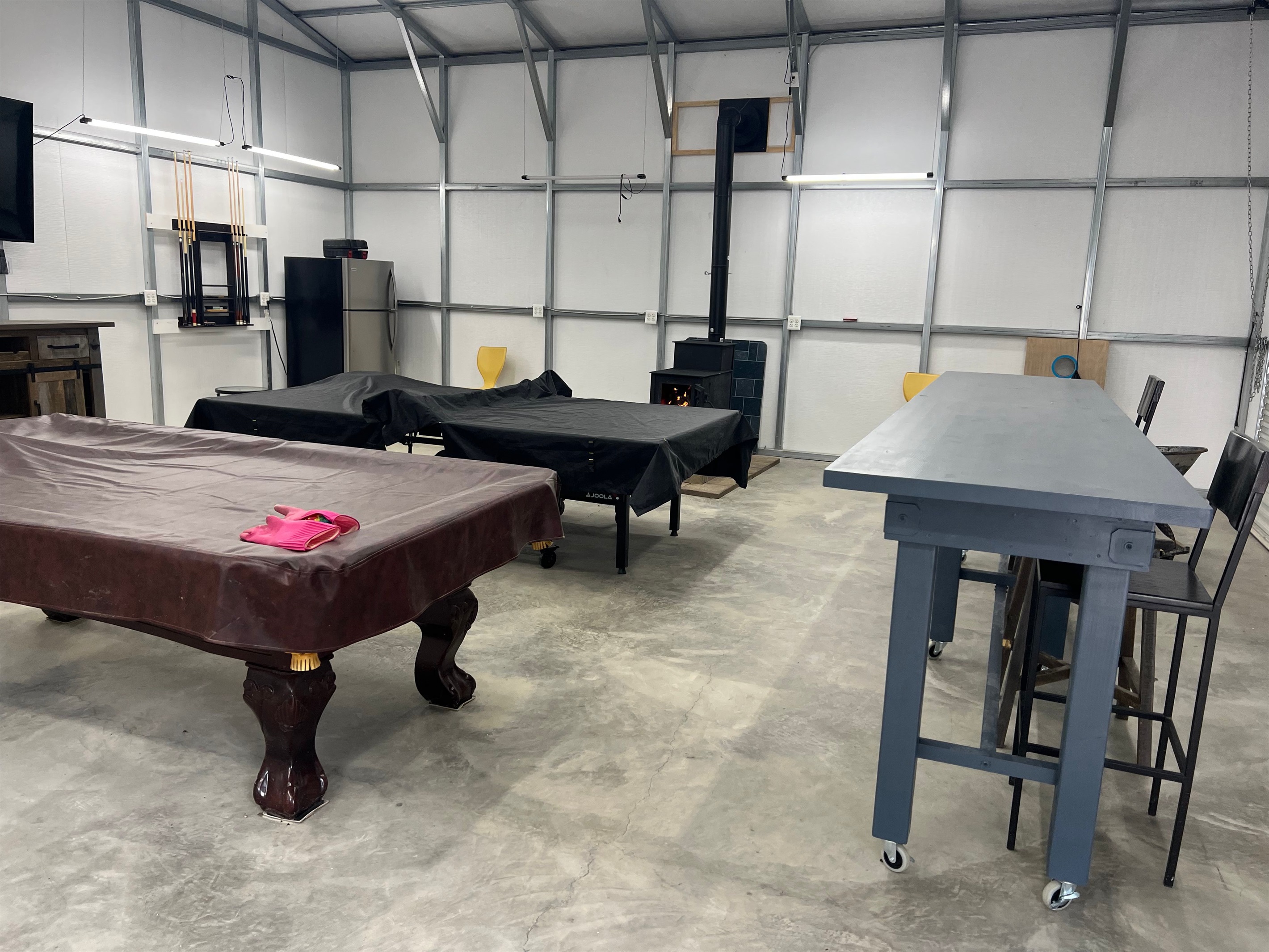The game room now has a smart TV and a stylish bar with seating.