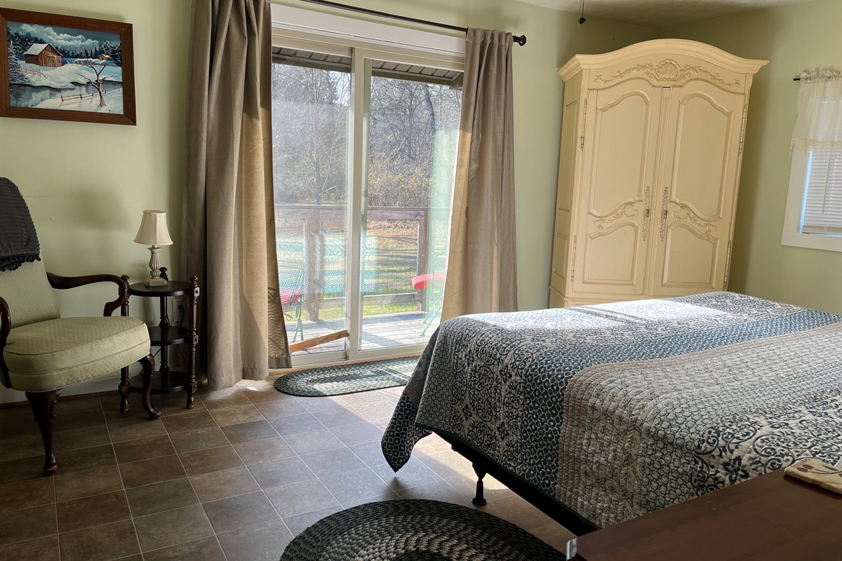Master bedroom with a king bed and a view.