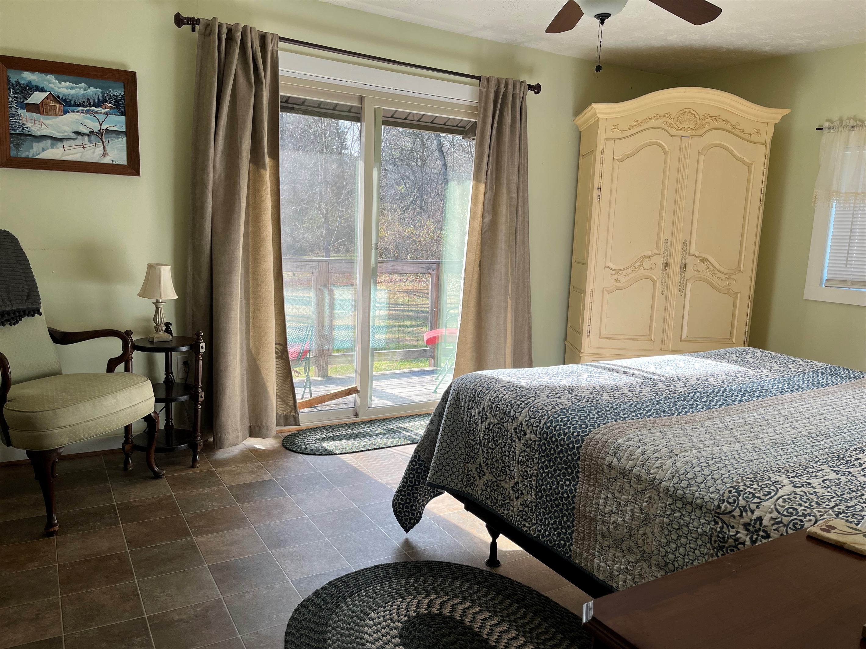 Master bedroom with a king bed and a view.