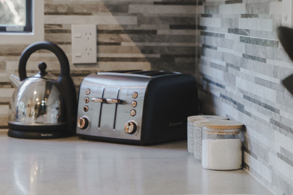 The kitchen includes a kettle, toaster, storage and usable bench space, giving Fernhill Mountain Escape the basics for simple meals and mornings.