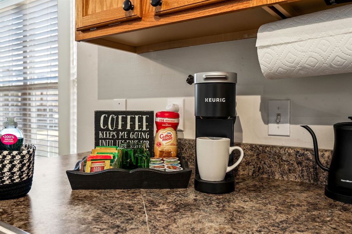 Enjoy a cozy coffee station with a Keurig, a selection of K-cups, teas, and creamer—perfect for starting your morning or winding down after a day of exploring.