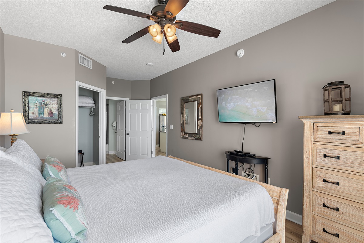 Spacious master bedroom features a King bed, Gulf views, balcony access, SMART TV w/ cable access, bathroom with dual vanity and shower/tub combo, and large closet.