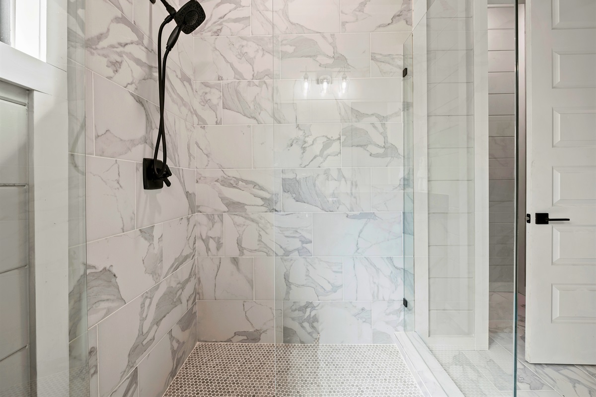 Escape to the clean lines and calming tile walk-in shower, designed for a refreshing solitude.