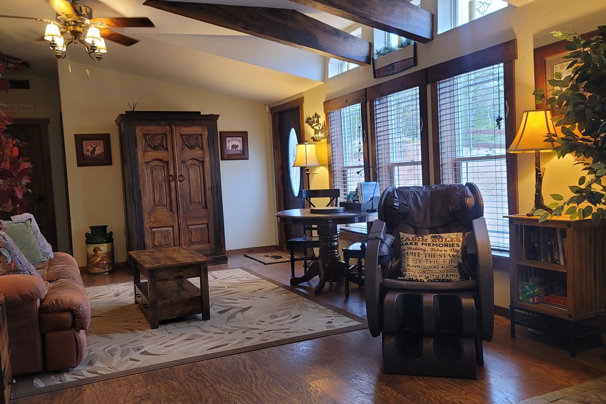 Reclining sofa in the second living area with the woodstove and massage chair and an armoire full of family friendly games and DVDs