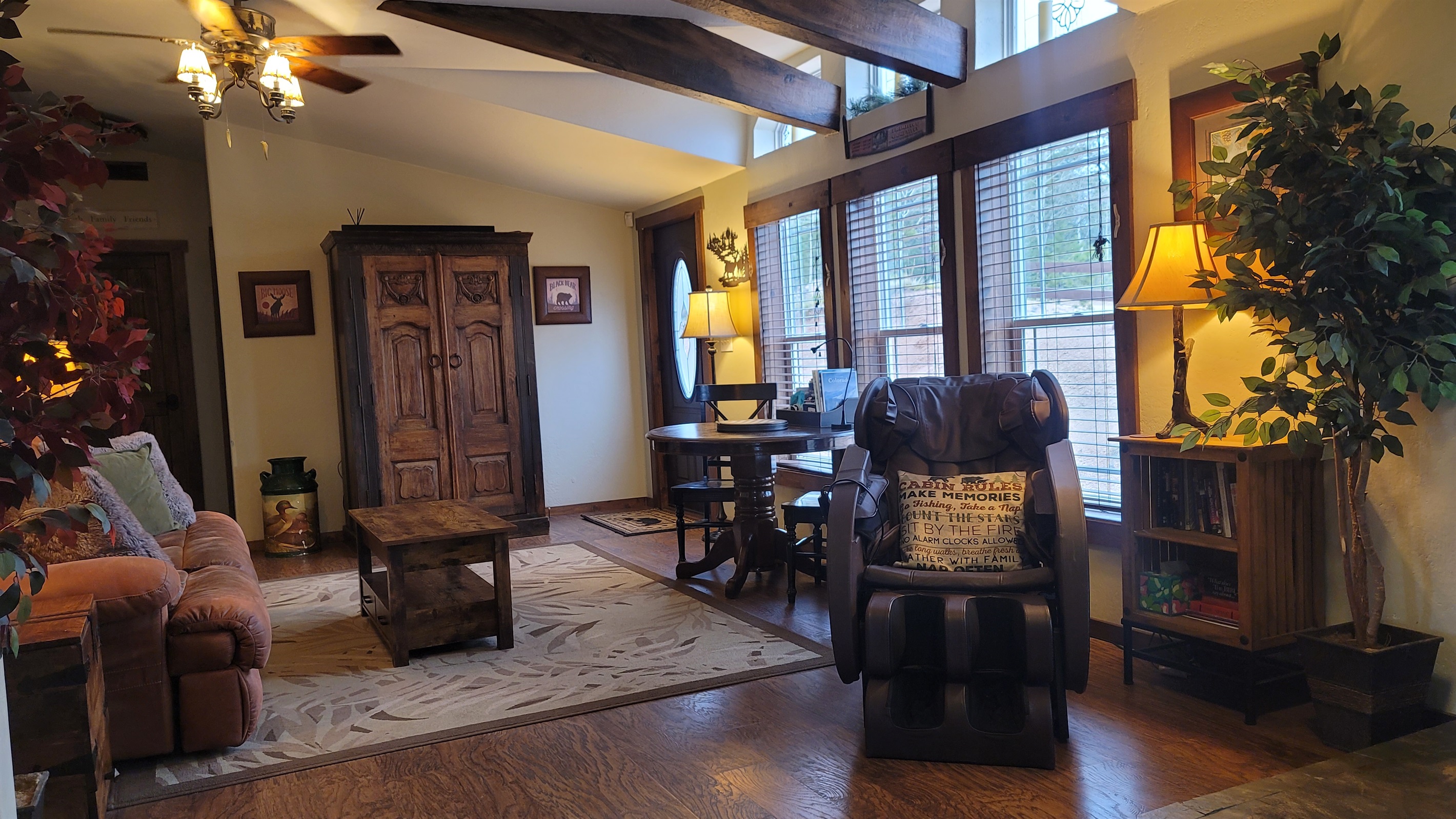 Reclining sofa in the second living area with the woodstove and massage chair and an armoire full of family friendly games and DVDs