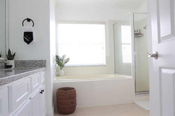 Relaxing spa-like master bathroom with double vanity, bath tub, shower and private room for toilet