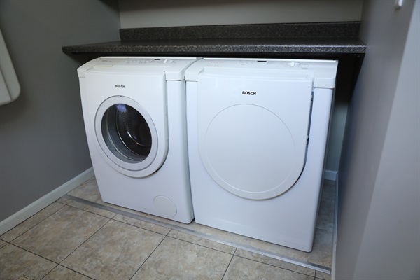 Laundry room showing front loaded washer and dryer