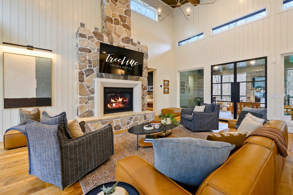 A stone fireplace anchors the space, giving you a cozy place to curl up and enjoy the soft glow of the fire.